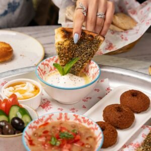 A delectable spread of Middle Eastern dishes featuring falafel, fresh vegetables, and creamy dips.