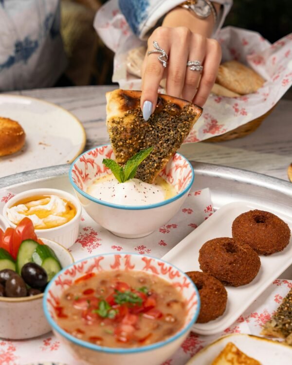 A delectable spread of Middle Eastern dishes featuring falafel, fresh vegetables, and creamy dips.