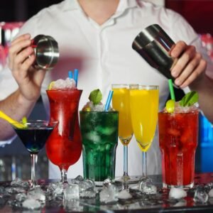 Vibrant assortment of cocktails prepared by a bartender in a dynamic bar setting.